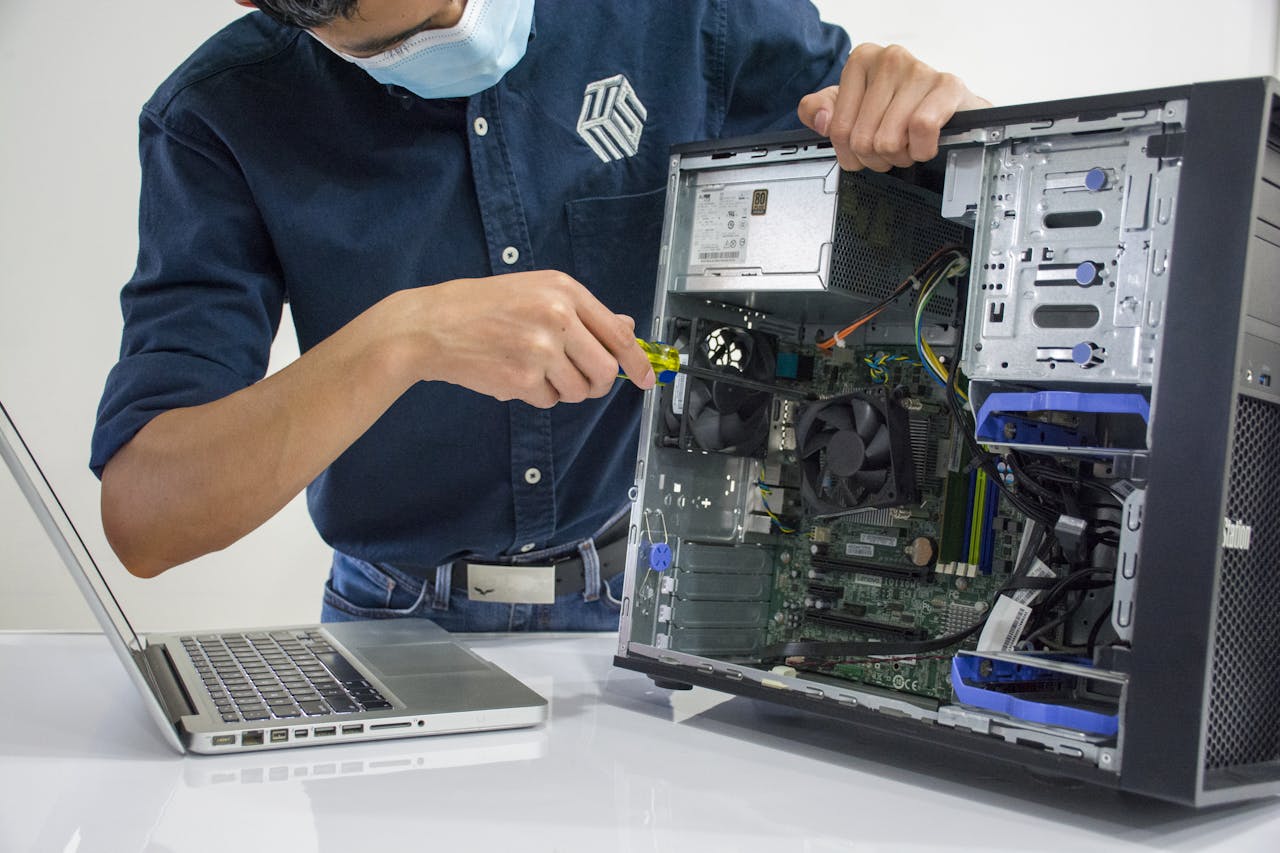 journey A technician repairs a desktop computer in an indoor setting, illustrating tech maintenance.